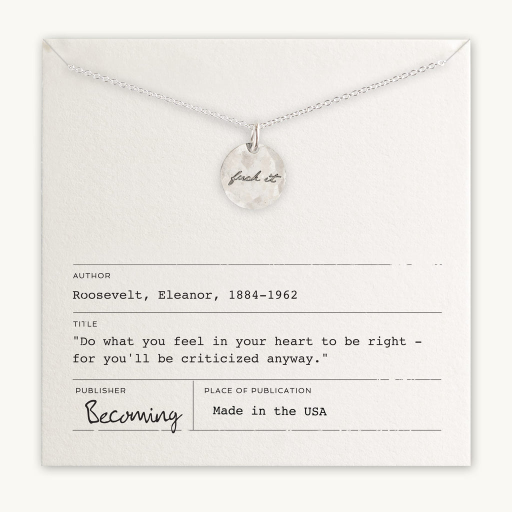 A Fuck It Necklace featuring a sterling silver circular pendant inscribed with "just do it" displayed above an inspirational quote by Eleanor Roosevelt on a card, by Becoming Jewelry.