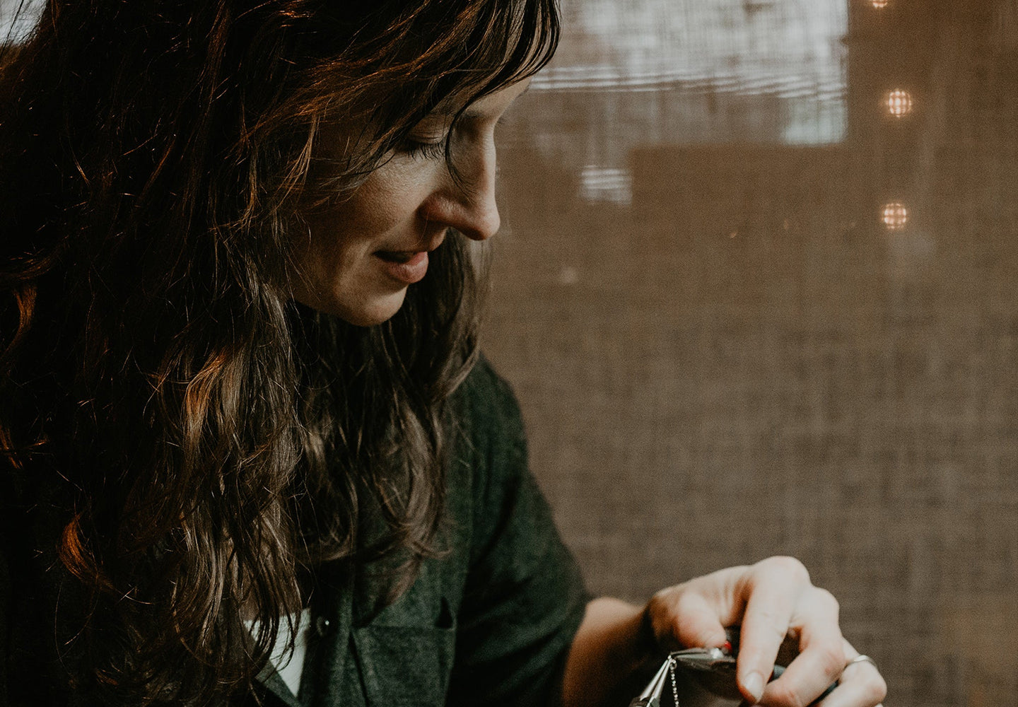 Woman with long hair working on jewelry