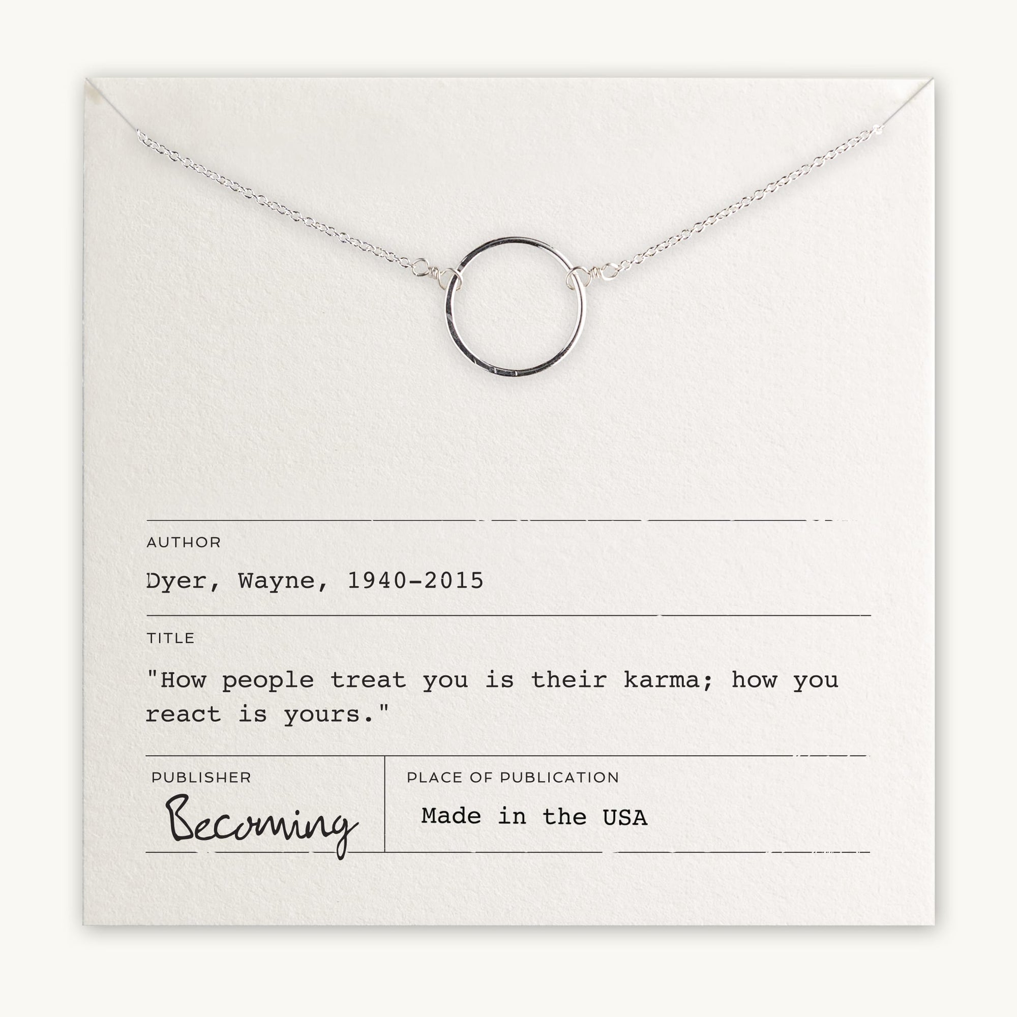 Silver and mixed metal circle pendant Karma Necklace displayed with an inspirational Wayne Dyer Charm on a fine cable chain, accompanied by a quote from Wayne Dyer on a card by Becoming Jewelry.