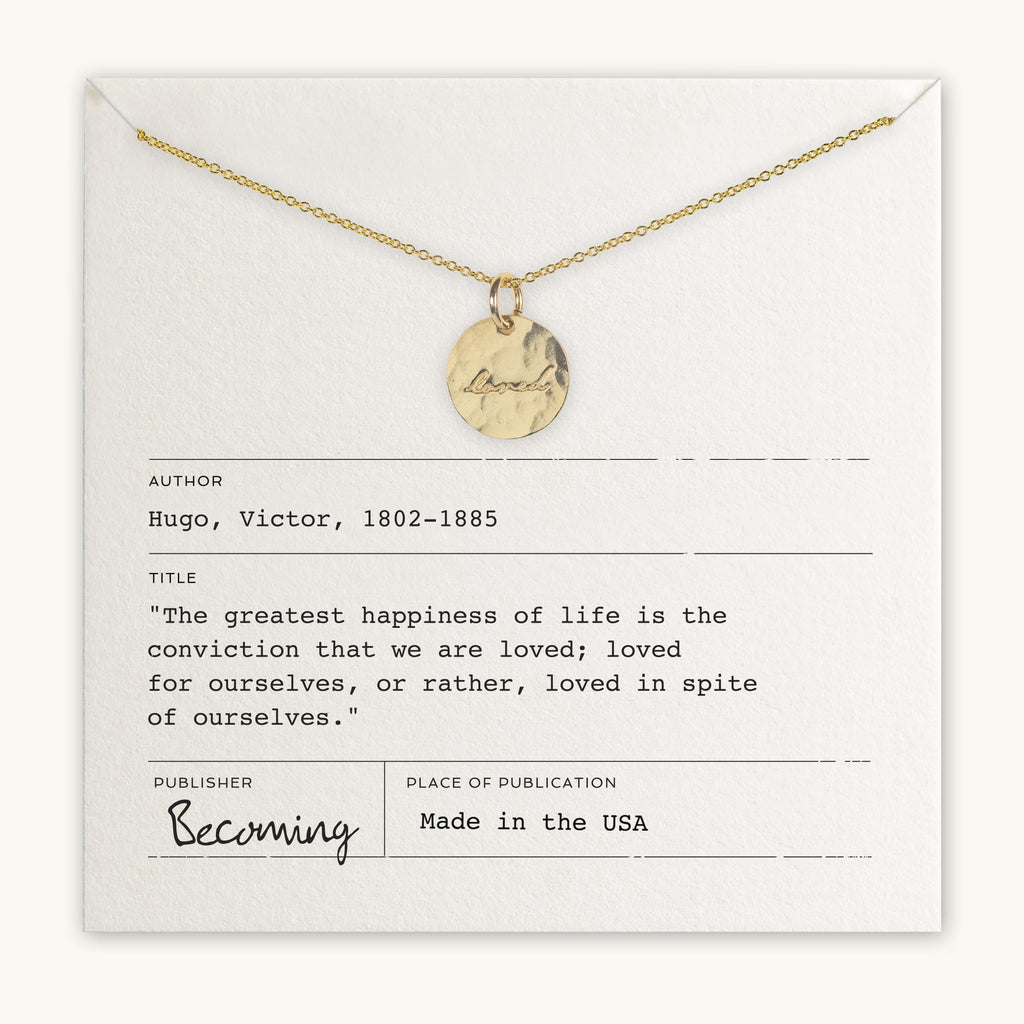 Loved Necklace by Becoming Jewelry displayed on a card with a Victor Hugo quote about happiness and love.