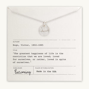 Loved Necklace with a marble-like pendant displayed on a card with a Victor Hugo quote by Becoming Jewelry.