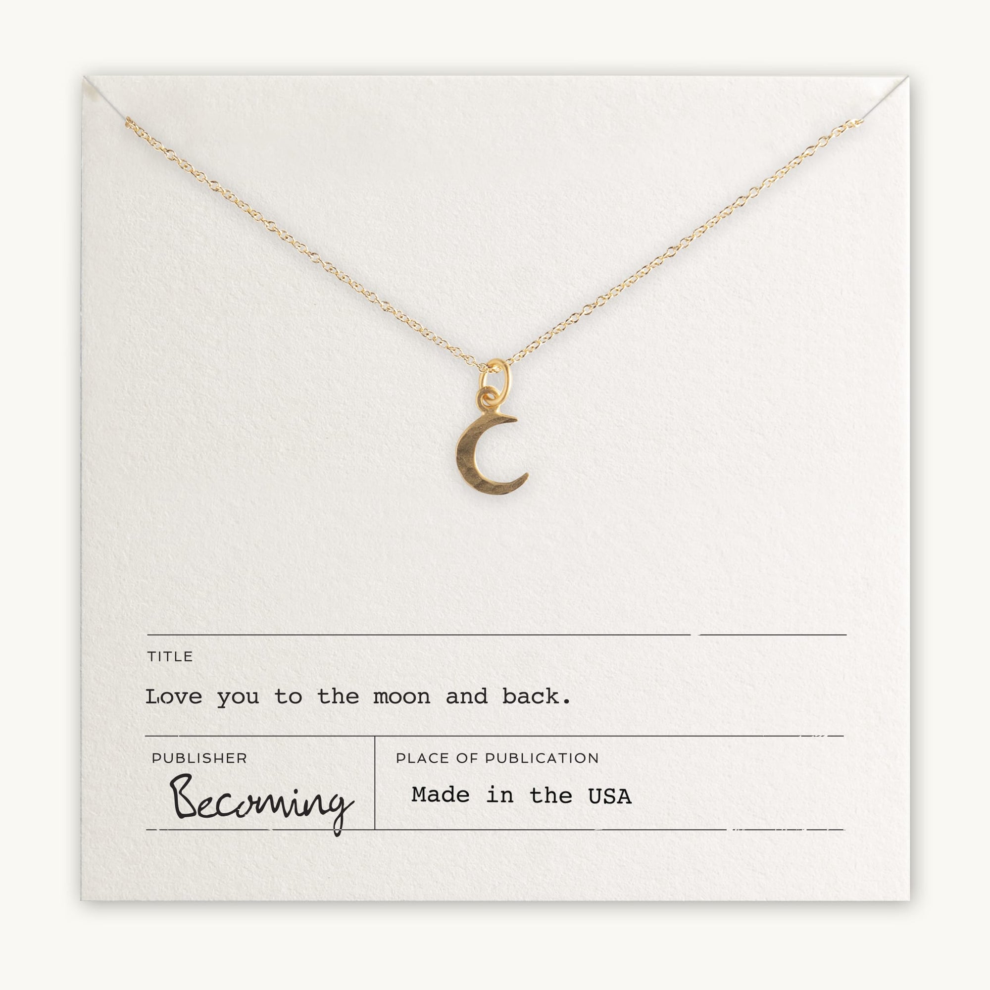 Gold-filled Love You To The Moon Necklace charm pendant on a chain displayed on a card with the inscription &quot;love you to the moon and back&quot; by Becoming Jewelry, made in the USA.