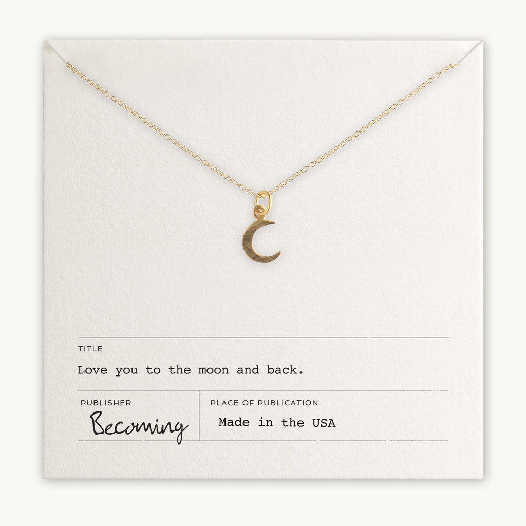Gold-filled Love You To The Moon Necklace charm pendant on a chain displayed on a card with the inscription "love you to the moon and back" by Becoming Jewelry, made in the USA.