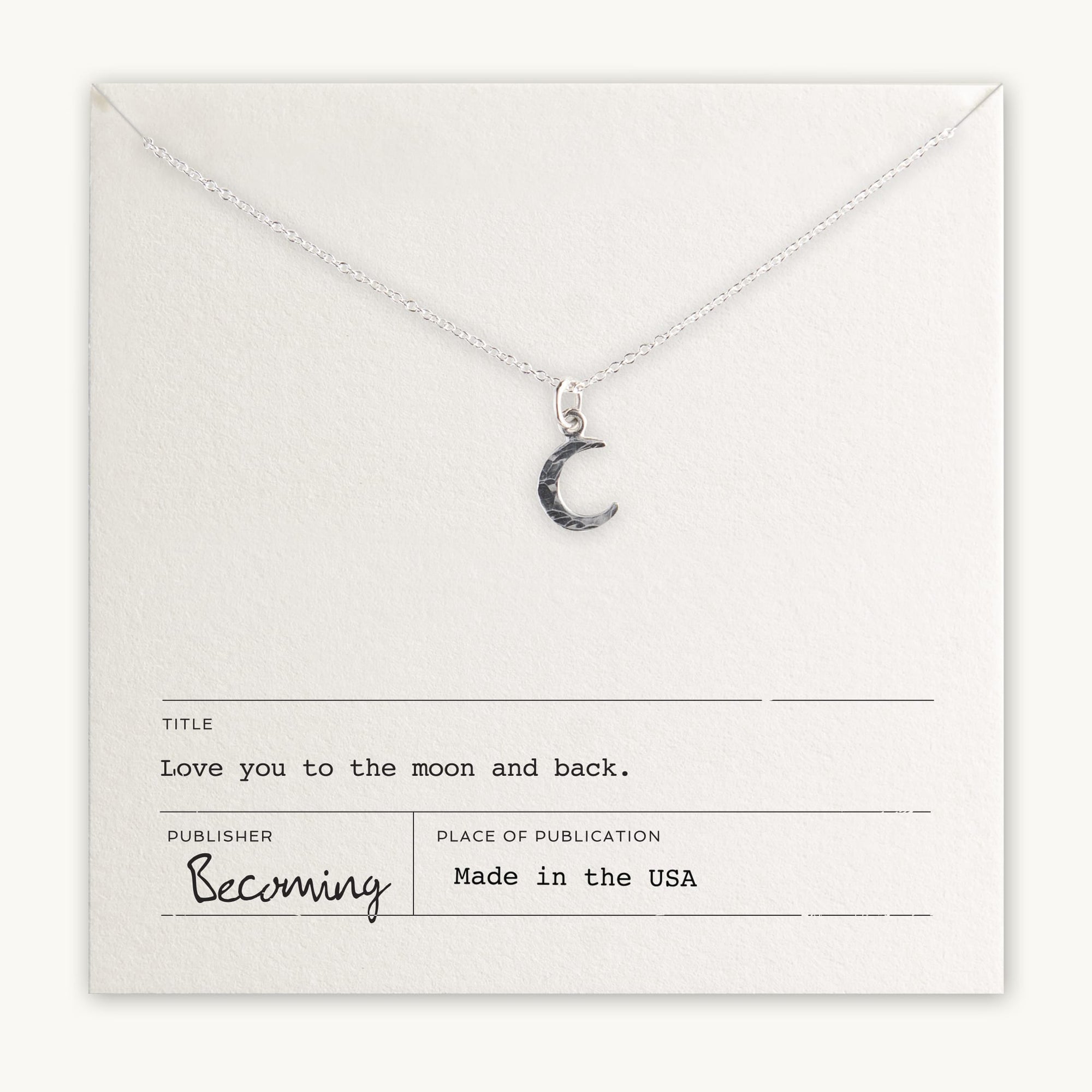 Becoming Jewelry&#39;s Love You To The Moon Necklace displayed on a card with the inscription &quot;love you to the moon and back.&quot; made in the USA.