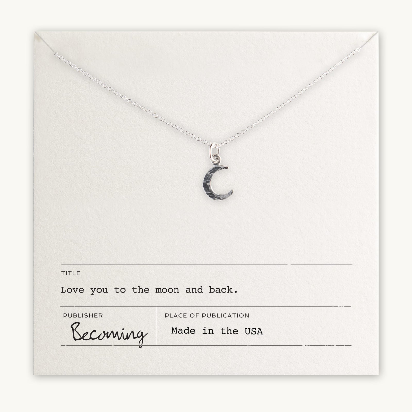 Becoming Jewelry's Love You To The Moon Necklace displayed on a card with the inscription 
