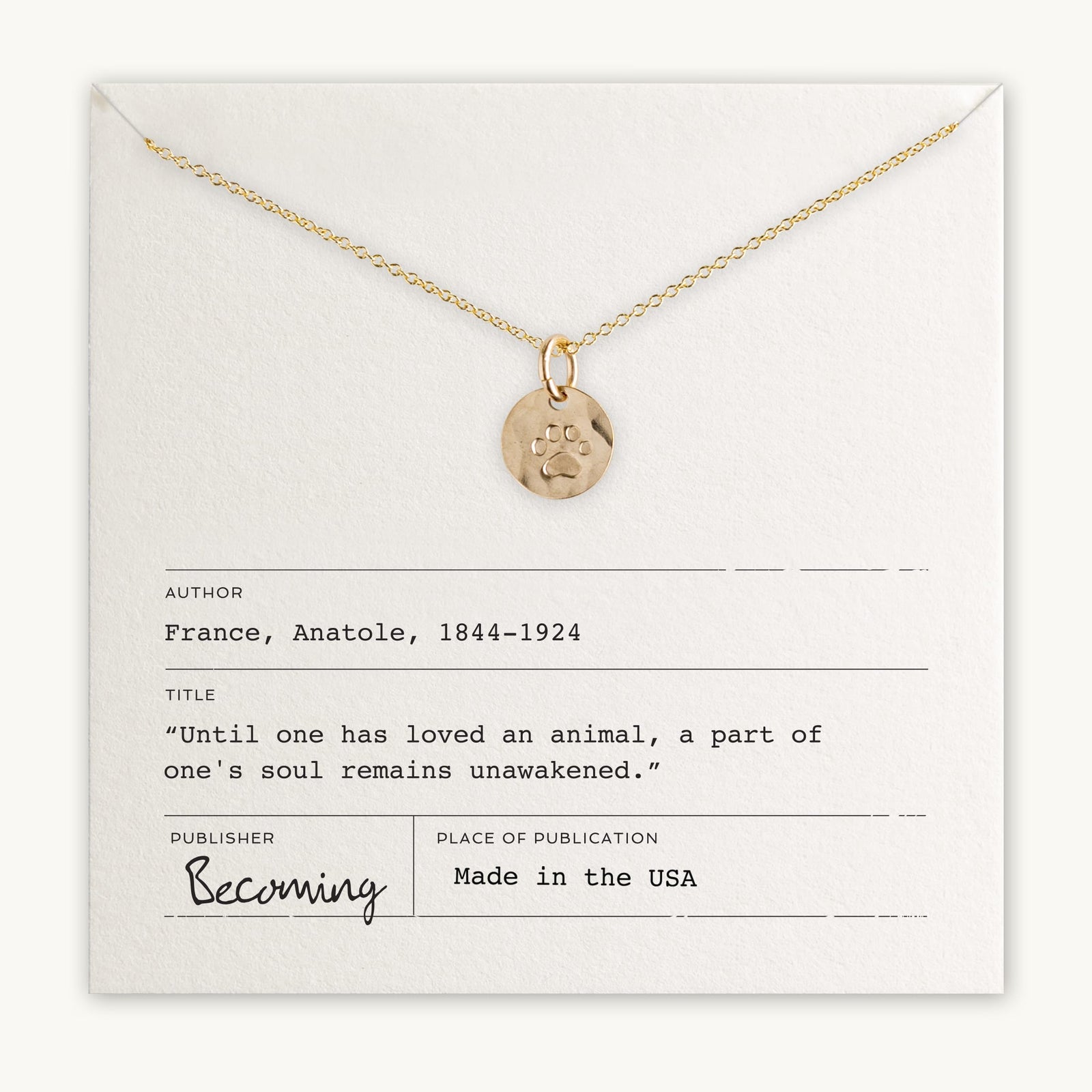 Becoming Jewelry's Paw Print Necklace displayed on a card with a quote about loving an animal, attributed to Anatole France.