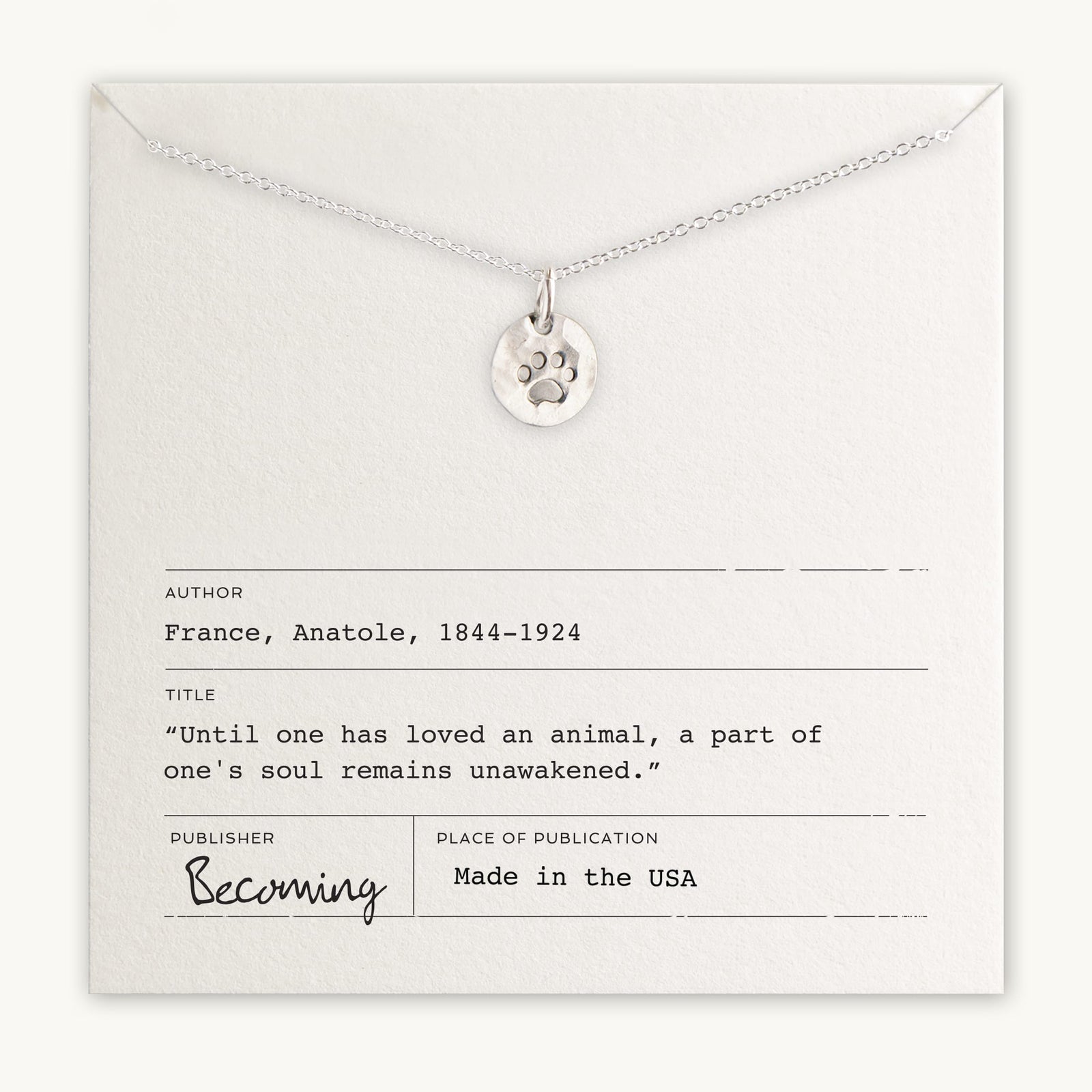 Becoming Jewelry's Paw Print Necklace with paw print charm pendant presented on a card with an Anatole France quote.