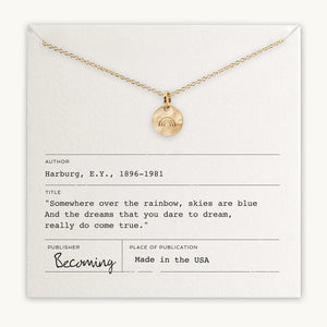 Becoming Jewelry's Over the Rainbow Necklace displayed on a card with an inspirational quote "somewhere over the rainbow, skies are blue, and the dreams that you dare to dream, really do come true.