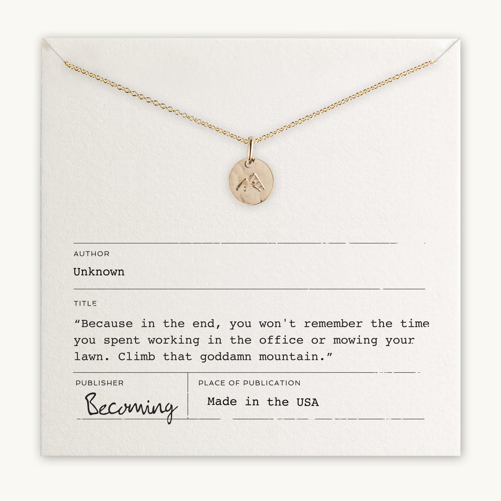 Climb That Mountain Necklace displayed on a card with an inspirational quote about climbing mountains and living memorable moments, labeled as &quot;Becoming Jewelry&quot; and &quot;made in the USA&quot;. This Mountain Charm piece is Gold Filled.