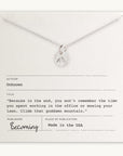 Climb That Mountain Necklace with a mountain charm pendant displayed on a card with an inspirational quote about life priorities and personal growth, titled "Becoming" by Becoming Jewelry.