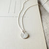 Becoming Jewelry's On Fire Necklace features a Flame Charm pendant on a textured background.