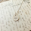 Becoming Jewelry's Trees Necklace with a trees charm pendant displayed on a background of handwritten text.